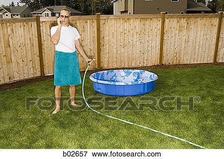 High angle view of an adult man talking on a mobile phone View Large Photo Image Stock Photo - High angle view of an adult man talking on a mobile phone. Fotosearch
