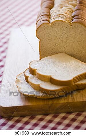 High angle view of bread slices on a cutting board View Large Photo Image Stock Photo - High angle view of bread slices on a cutting board. Fotosearch