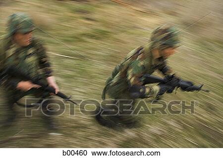 High angle view of two soldiers running on a field with their rifles View Large Photo Image Stock Image - High angle view of two soldiers running on a field with their rifles. Fotosearch