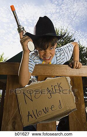Low angle view of a boy dressed as a cowboy View Large Photo Image Stock Photo - Low angle view of a boy dressed as a cowboy. Fotosearch