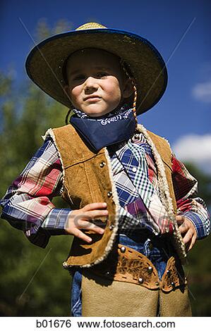 Low angle view of a boy in a cowboy costume View Large Photo Image Stock Photograph - Low angle view of a boy in a cowboy costume. Fotosearch