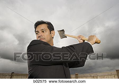 Low angle view of a businessman swinging a shovel View Large Photo Image Stock Photography - Low angle view of a businessman swinging a shovel. Fotosearch