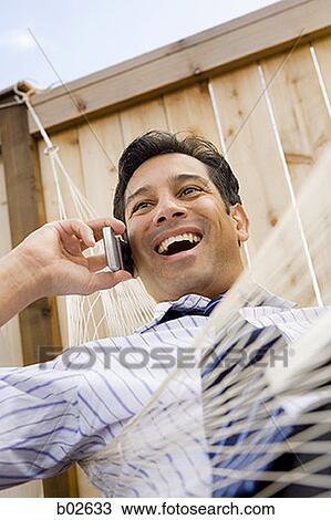 Low angle view of a businessman talking on the mobile phone View Large Photo Image Stock Image - Low angle view of a businessman talking on the mobile phone. Fotosearch