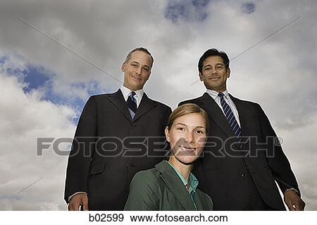 Stock Photo - Low angle view of a businesswoman and two businesswomen smiling. Fotosearch