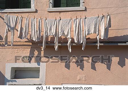 Low angle view of a clothesline outside a building View Large Photo Image Picture - Low angle view of a clothesline outside a building. Fotosearch