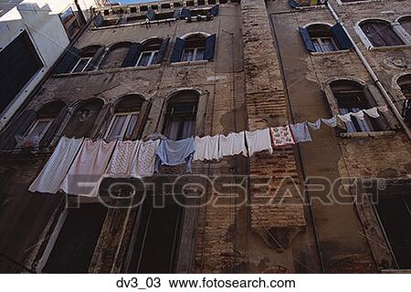Stock Image - Low angle view of a clothesline outside a building. Fotosearch