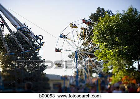 Stock Image - Low angle view of a ferries wheel in an amusement park. Fotosearch