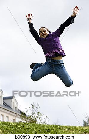 Low angle view of a girl jumping View Large Photo Image Stock Image - Low angle view of a girl jumping. Fotosearch