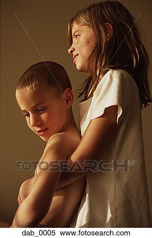 Stock Photography - Low angle view of a girl lifting her brother. Fotosearch
