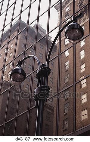 Low angle view of a lamppost outside a building View Large Photo Image Stock Photo - Low angle view of a lamppost outside a building. Fotosearch