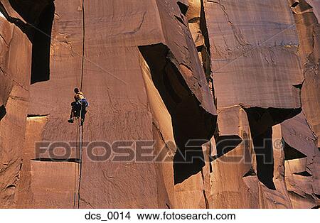 Low angle view of a man rock climbing View Large Photo Image Picture - Low angle view of a man rock climbing. Fotosearch