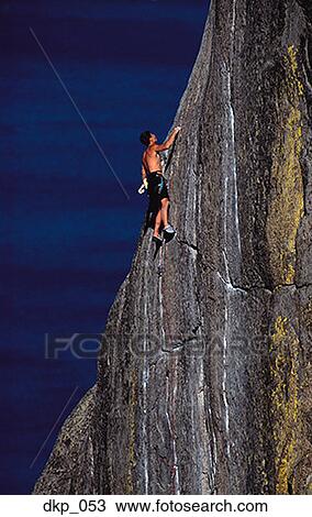 Low angle view of a man rock climbing View Large Photo Image Stock Image - Low angle view of a man rock climbing. Fotosearch