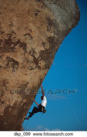 Low angle view of a man rock climbing View Large Photo Image Stock Photo - Low angle view of a man rock climbing. Fotosearch