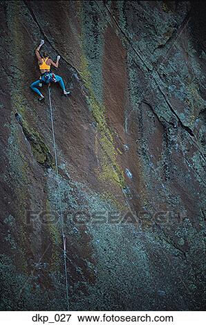 Low angle view of a person rock climbing View Large Photo Image Stock Photo - Low angle view of a person rock climbing. Fotosearch