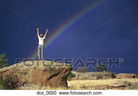 Low angle view of a person standing on top of a rock formation View Large Photo Image Stock Image - Low angle view of a person standing on top of a rock formation. Fotosearch