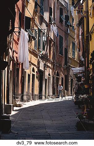 Low angle view of a person walking down an alley View Large Photo Image Stock Photo - Low angle view of a person walking down an alley. Fotosearch