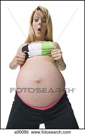 Low angle view of a very pregnant woman looking at her stomach View Large Photo Image Stock Photography - Low angle view of a very pregnant woman looking at her stomach. Fotosearch