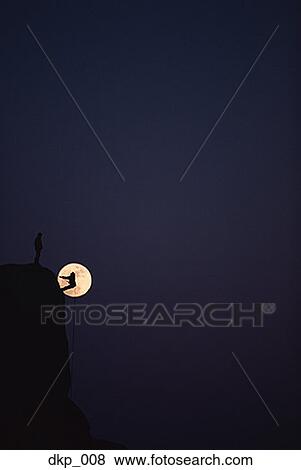 Low angle view of silhouettes of two people rock climbing at night View Large Photo Image Stock Photo - Low angle view of silhouettes of two people rock climbing at night. Fotosearch