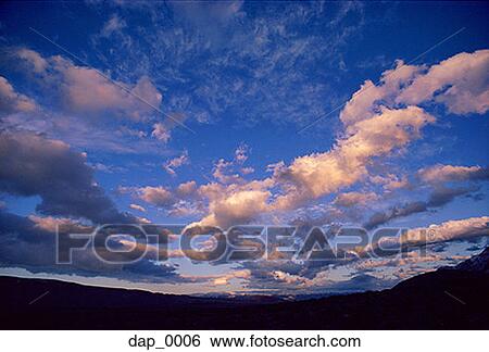 Low angle view of storm clouds over landscape View Large Photo Image Stock Photograph - Low angle view of storm clouds over landscape. Fotosearch