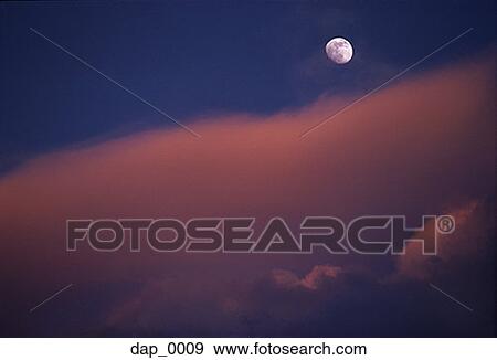 Low angle view of the moon over clouds View Large Photo Image Stock Photo - Low angle view of the moon over clouds. Fotosearch