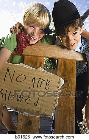 Stock Photography - Low angle view of two boys dressed as cops and robbers. Fotosearch