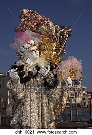 Stock Image - Low angle view of two people in masquerade costumes. Fotosearch