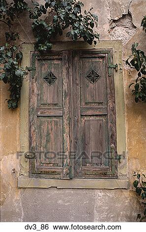Low angle view of wooden shutters on a window View Large Photo Image Stock Photograph - Low angle view of wooden shutters on a window. Fotosearch