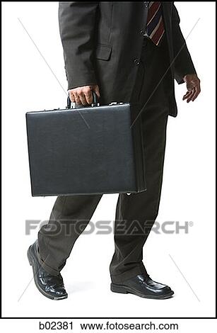 Low section view of a businessman carrying a briefcase View Large Photo Image Stock Image - Low section view of a businessman carrying a briefcase. Fotosearch