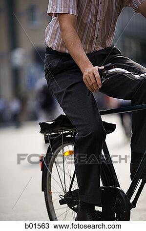 Low section view of a man riding a bicycle View Large Photo Image Stock Image - Low section view of a man riding a bicycle. Fotosearch