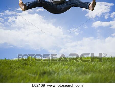 Low section view of a young man jumping View Large Photo Image Stock Photo - Low section view of a young man jumping. Fotosearch