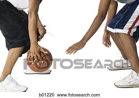 Low section view of two young men playing basketball View Large Photo Image Stock Image - Low section view of two young men playing basketball. Fotosearch