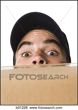 Mailman peeking over a cardboard box View Large Photo Image Stock Photo - Mailman peeking over a cardboard box. Fotosearch
