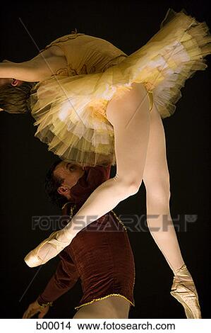 Picture - Male ballet dancer supporting a female ballerina. Fotosearch