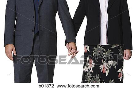 Man and a woman holding hands View Large Photo Image Stock Image - Man and a woman holding hands. Fotosearch