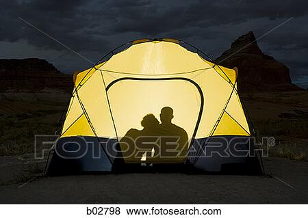 Man and a woman sitting in a tent View Large Photo Image Stock Photo - Man and a woman sitting in a tent. Fotosearch