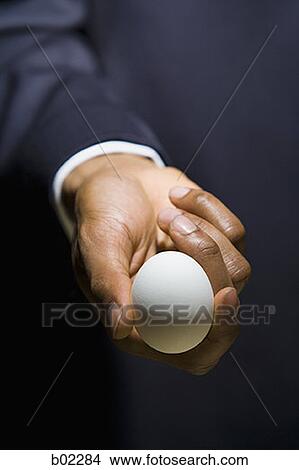 Man holding an egg View Large Photo Image Picture - Man holding an egg. Fotosearch