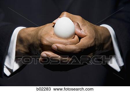 Man holding an egg View Large Photo Image Stock Image - Man holding an egg. Fotosearch