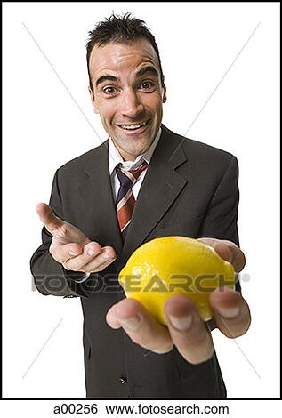 Man holding out a lemon View Large Photo Image Stock Photograph - Man holding out a lemon. Fotosearch