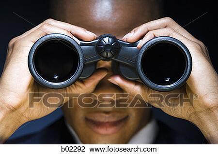 Man looking through binoculars View Large Photo Image Stock Image - Man looking through binoculars. Fotosearch