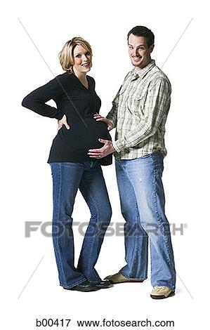Stock Photo - Man touching his pregnant wife's abdomen. Fotosearch