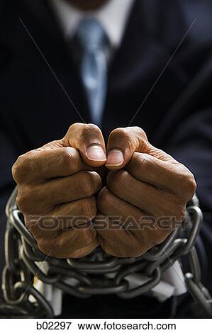 Man with chains around wrists View Large Photo Image Stock Photo - Man with chains around wrists. Fotosearch