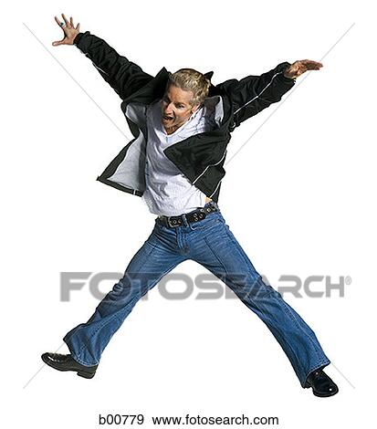 Stock Photo - Mid adult man jumping. Fotosearch