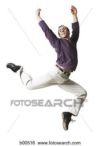 Mid adult man jumping with his arms raised View Large Photo Image Stock Photograph - Mid adult man jumping with his arms raised. Fotosearch