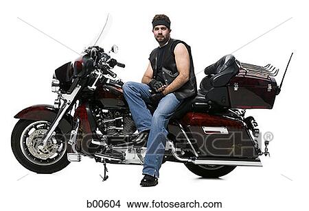 Mid adult man sitting on a motorcycle View Large Photo Image Picture - Mid adult man sitting on a motorcycle. Fotosearch