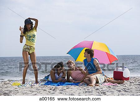 Mid adult men and women on the beach View Large Photo Image Stock Photography - Mid adult men and women on the beach. Fotosearch