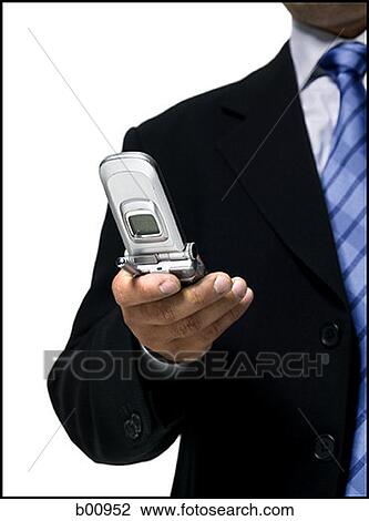 Mid section view of a businessman using a mobile phone View Large Photo Image Stock Image - Mid section view of a businessman using a mobile phone. Fotosearch