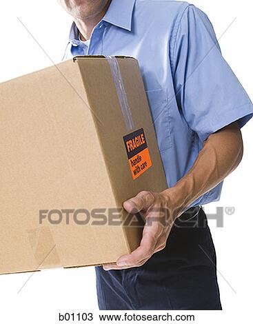 Mid section view of a delivery man carrying a box View Large Photo Image Stock Image - Mid section view of a delivery man carrying a box. Fotosearch