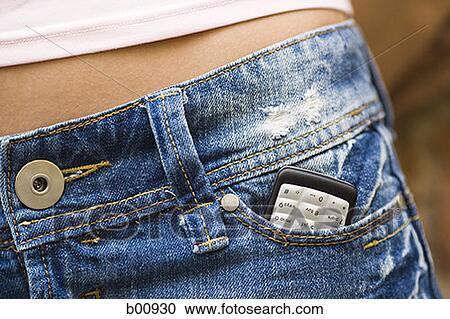 Mid section view of a mobile phone in a young woman's pocket View Large Photo Image Stock Image - Mid section view of a mobile phone in a young woman's pocket. Fotosearch