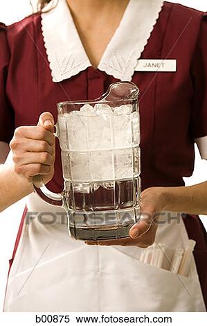 Mid section view of a waitress holding a jug of water View Large Photo Image Stock Photography - Mid section view of a waitress holding a jug of water. Fotosearch