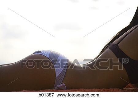 Mid section view of a young woman lying outdoors View Large Photo Image Stock Photo - Mid section view of a young woman lying outdoors. Fotosearch